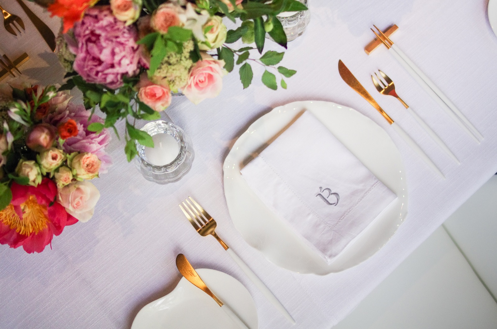BLANCHE private dining table — gold cutlery with chopsticks, monogrammed napkin, vivid peonies and roses